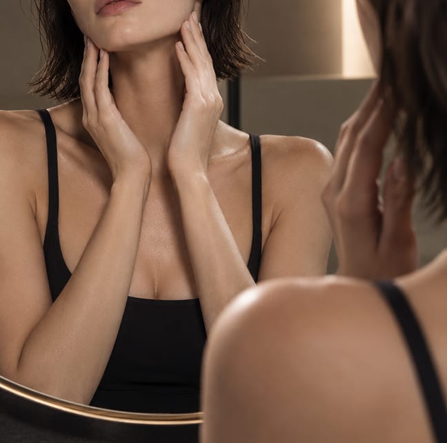 Woman touching her neck, seeking better results for skin laxity