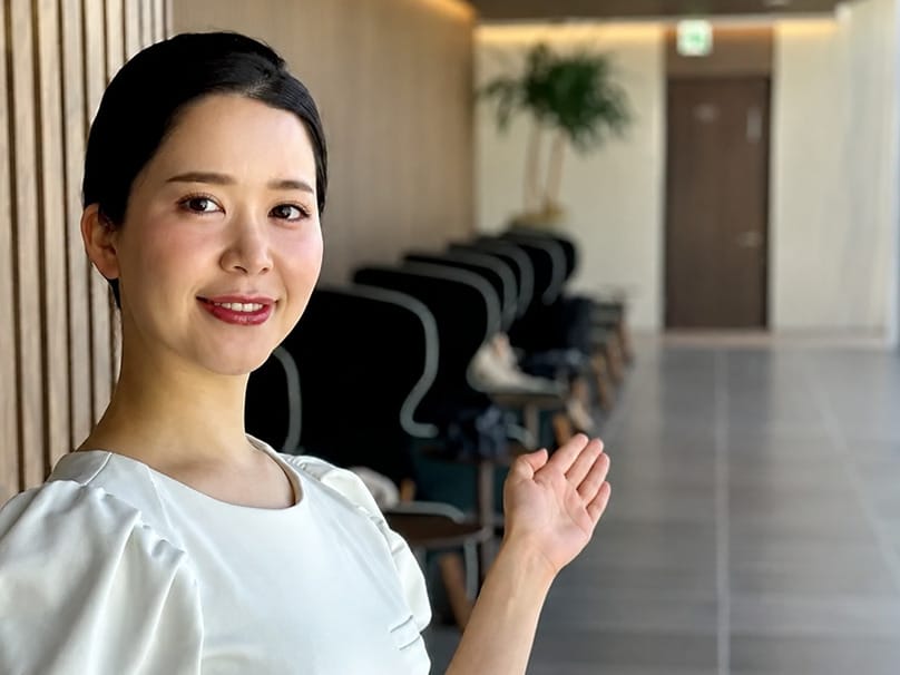 Staff member welcoming a patient in a warm, hospitality-focused clinic setting