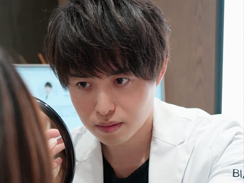Doctor closely examining a patient's face during a consultation