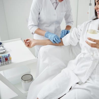 A woman receiving an IV infusion.