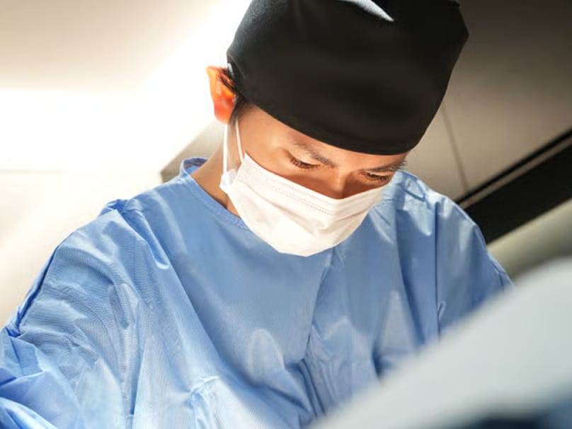 Surgeon at BIANCA CLINIC focused during a breast procedure